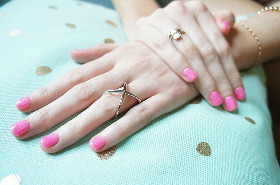 person wearing silver-colored ring, rings, hand, pink nail polish