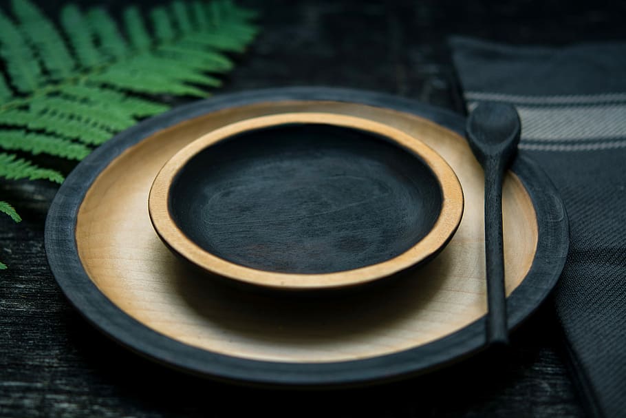 round black-and-brown wooden plate, black and brown saucer and plate on table HD wallpaper