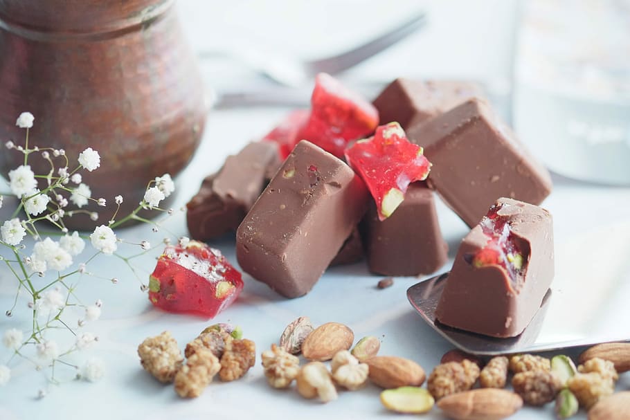 Chocolate Covered Turkish Delights, chocolate with peanuts on white surface HD wallpaper