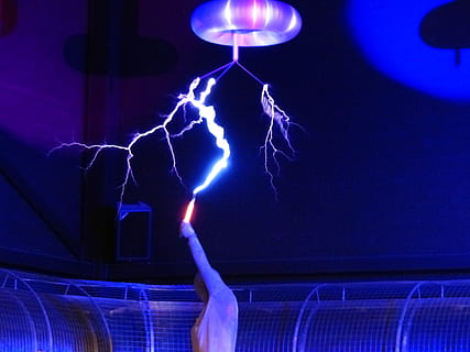 person holding orange tool with lightning effect above ceiling HD wallpaper