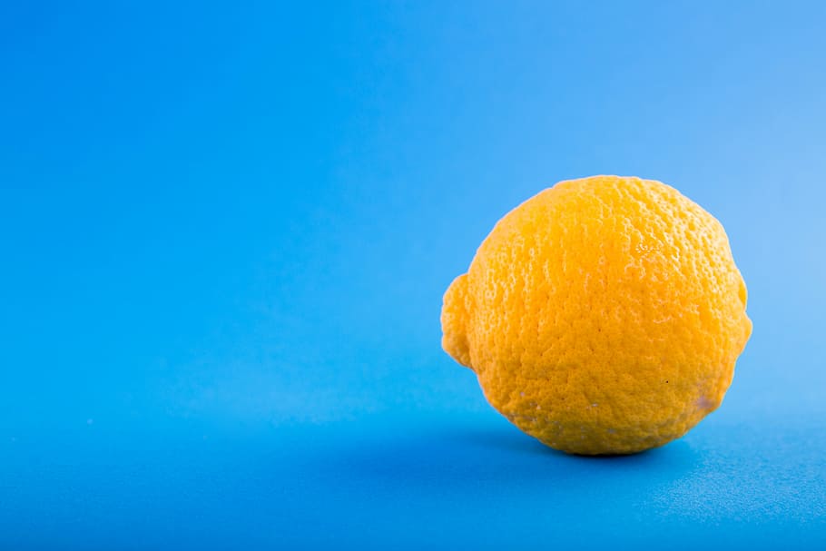 lemon fruit closeup photography, blue, table, juicy, citrus HD wallpaper