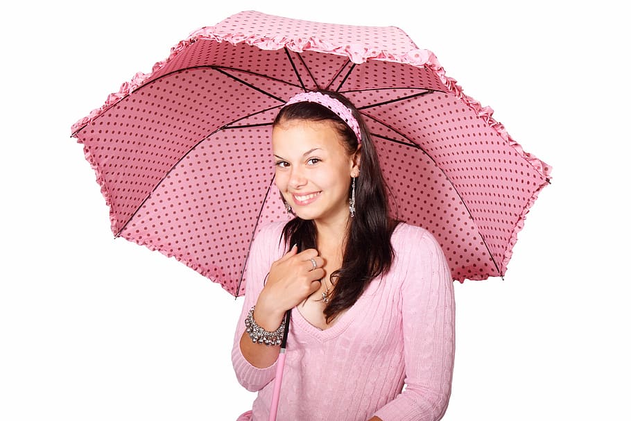 woman wearing pink scoop-neck sweater using umbrella, dots, dotted