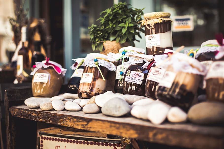 jars on brown wooden table, stones, bottle, food, display, commercial, HD wallpaper