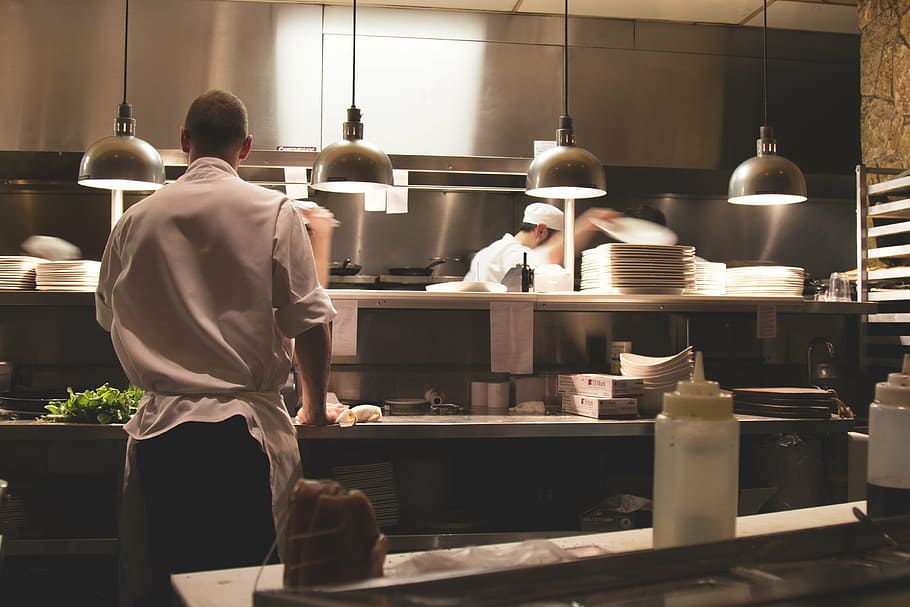 man in chef uniform standing near counter, kitchen, work, restaurant