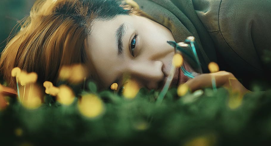 woman lying on green grass, person, brown, hoodie, laying, field HD wallpaper