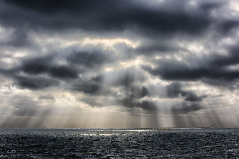 photography of sun raise over cloudy sky and body of water HD wallpaper
