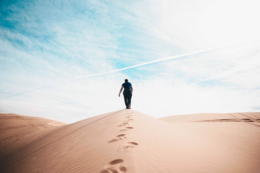 man walking on desert, person walking on sand, dune, footprint
