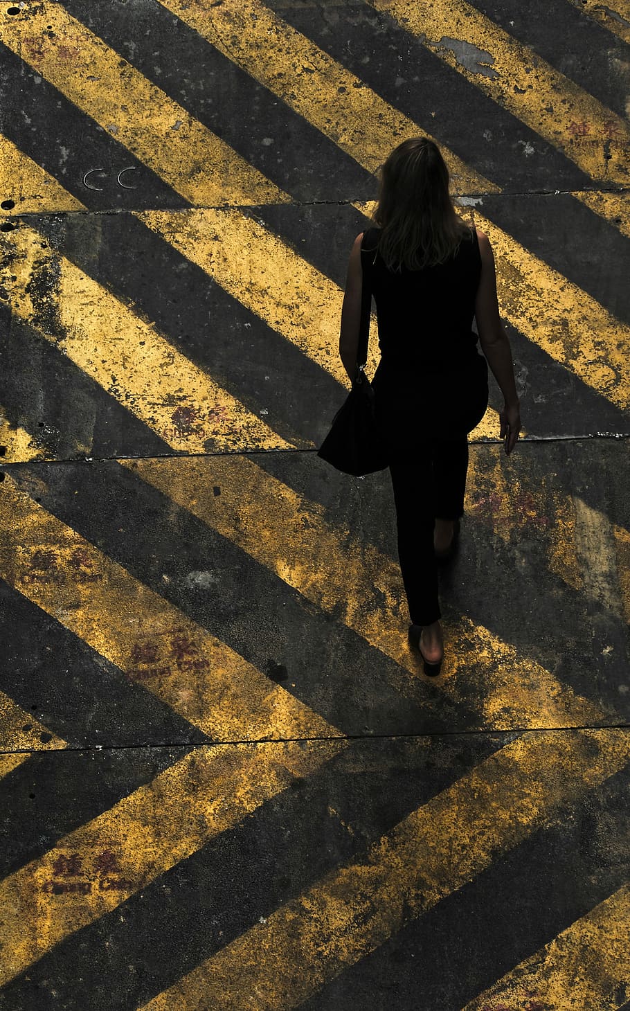 woman with shoulder walking on pedestrian lane, aerial view photography of woman walking on pedestrian lane HD wallpaper