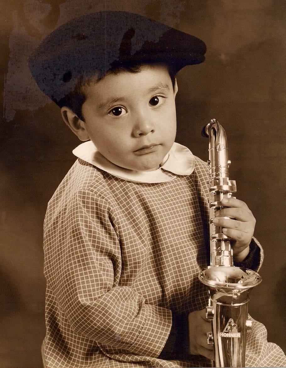 boy holding trumpet while sitting, saxophone, child, classical music