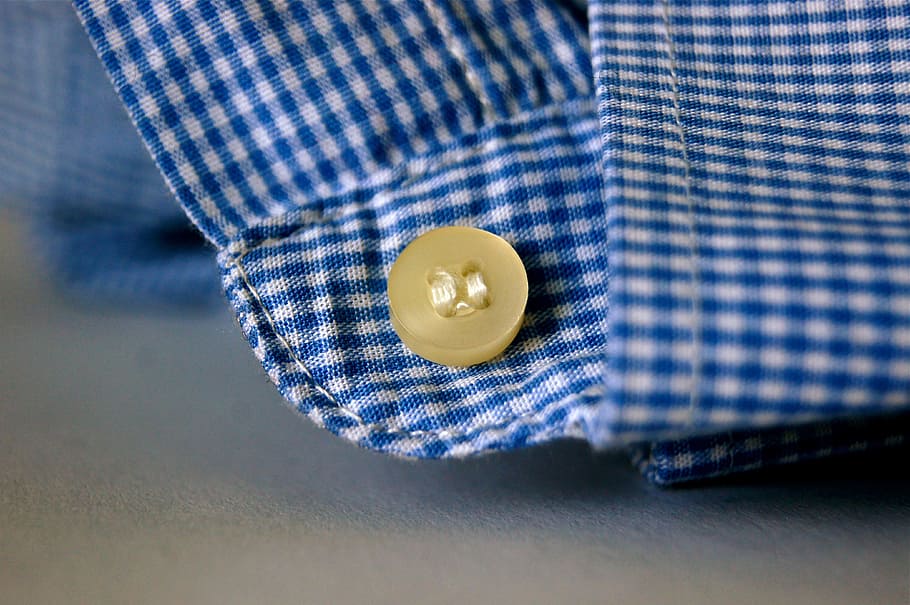 brown button on blue and white plaid textile photo, fabric, sew