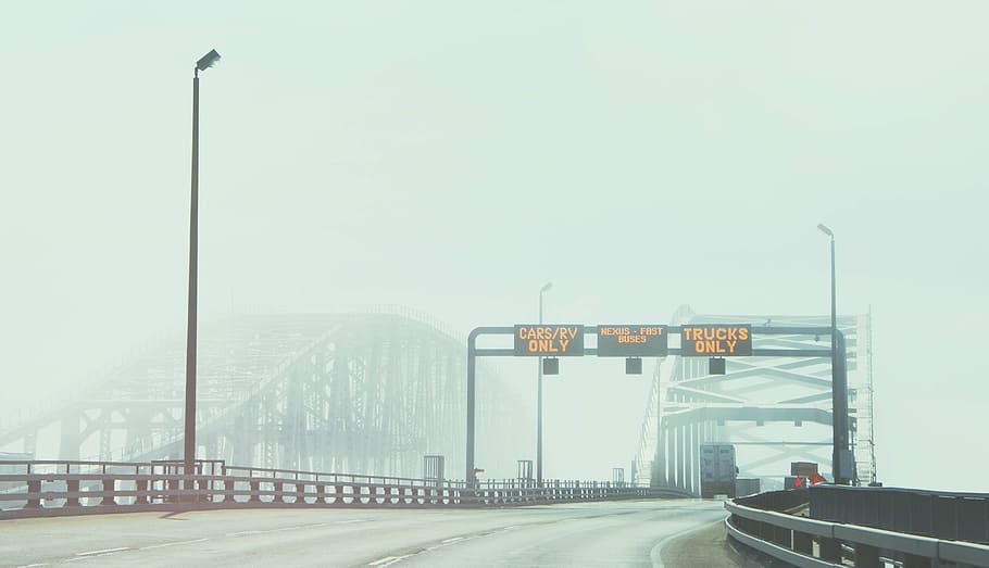 foggy bridge, 3-lane highway with LED signages at daytime, roadsign HD wallpaper