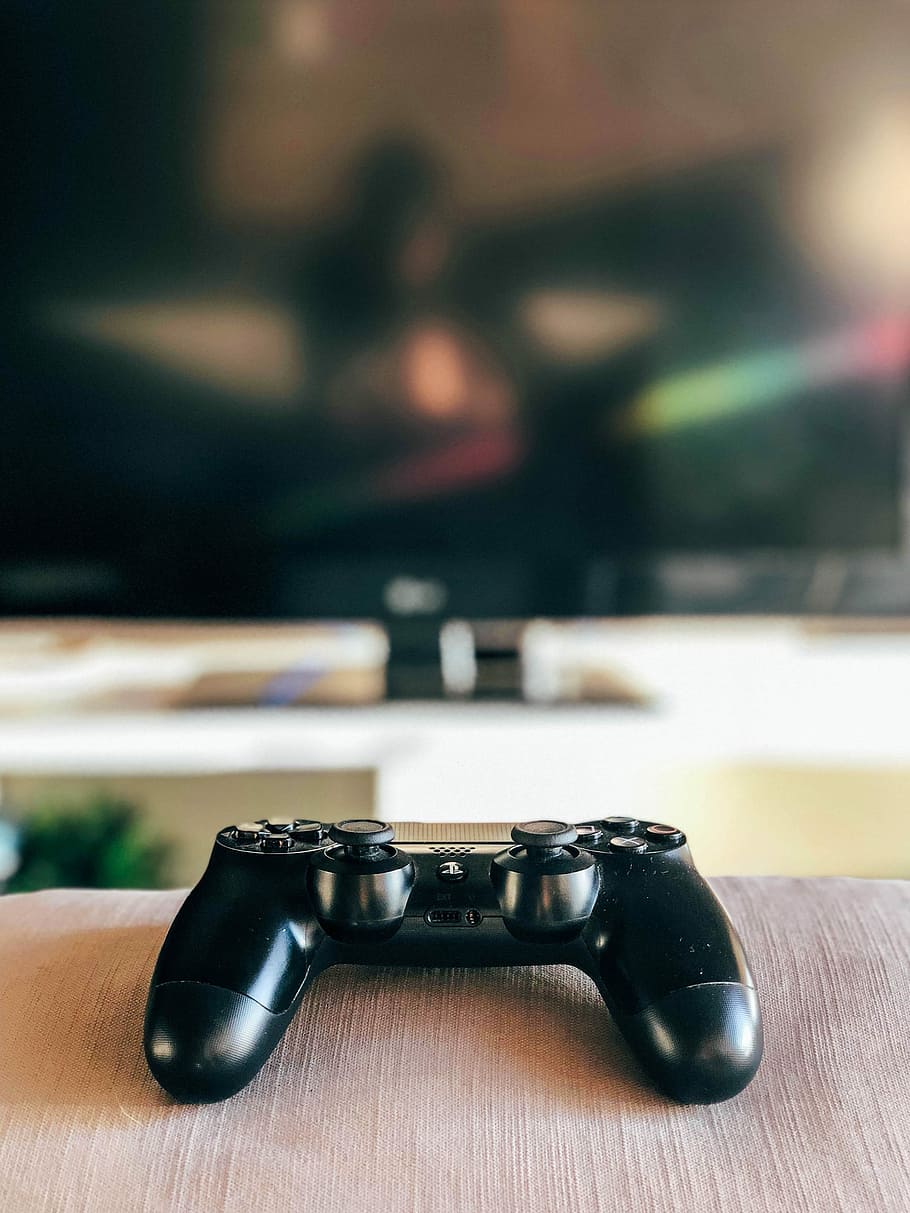 dept of field photography of black Sony PS4 DualShock 4 controller on grey cloth, shallow focus photography of black Sony DualShock 4 HD wallpaper