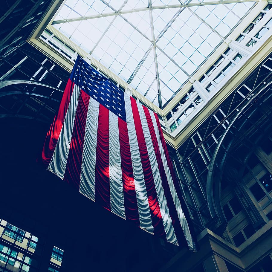 worm's eyeview photo of glass ceiling, low-angle photography of flag of America
