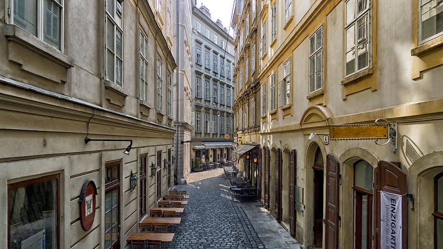 pathway between concrete buildings, vienna, austria, café, shops