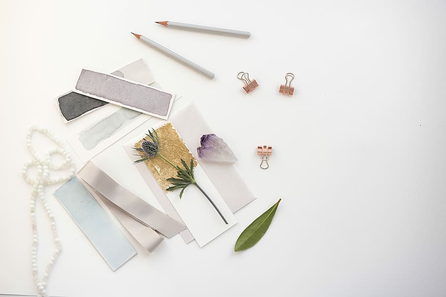 flowers on card near pencil, flat lay photography of decorative papers, clip, and pencil HD wallpaper