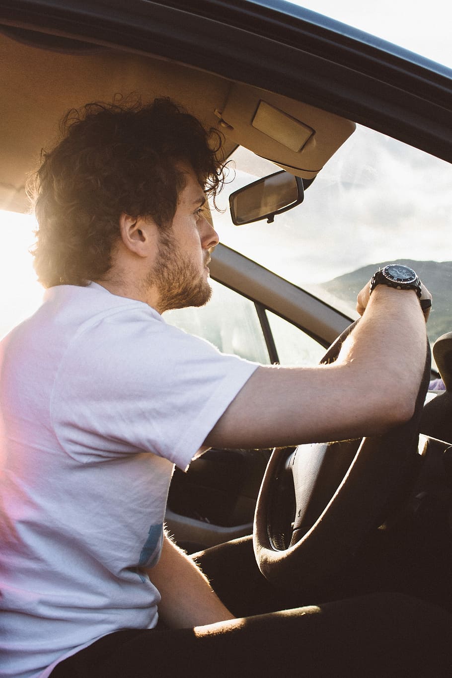 man holding steering wheel, man sitting inside the car during daytime HD wallpaper
