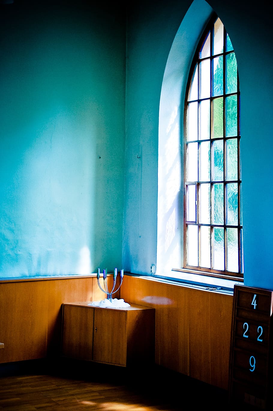 closed brown wooden cabinet beside window, rest, church window