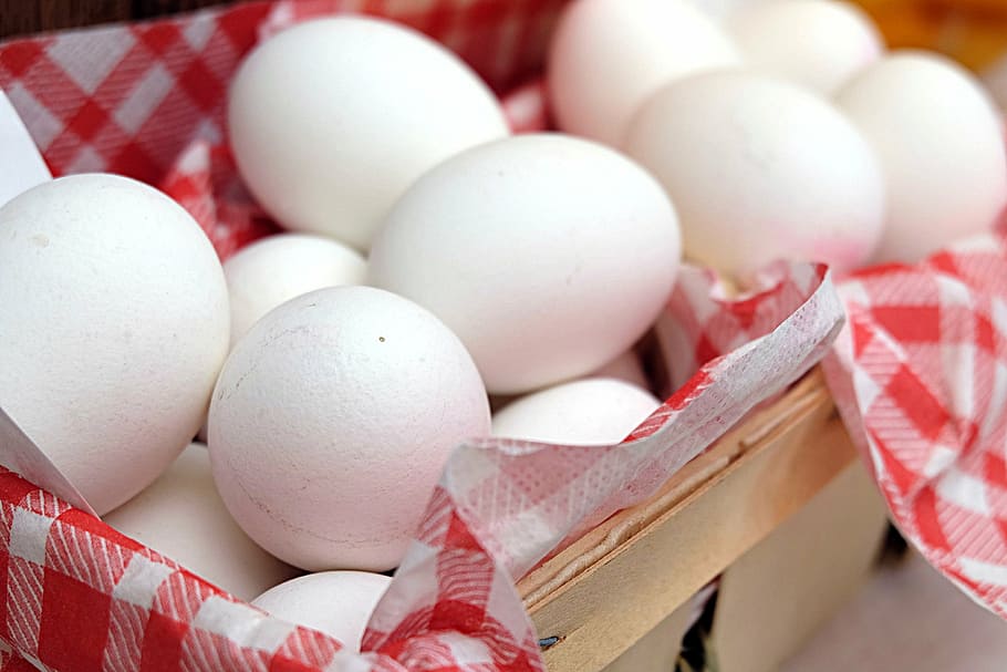shallow focus photography of chicken eggs in wicker basket HD wallpaper
