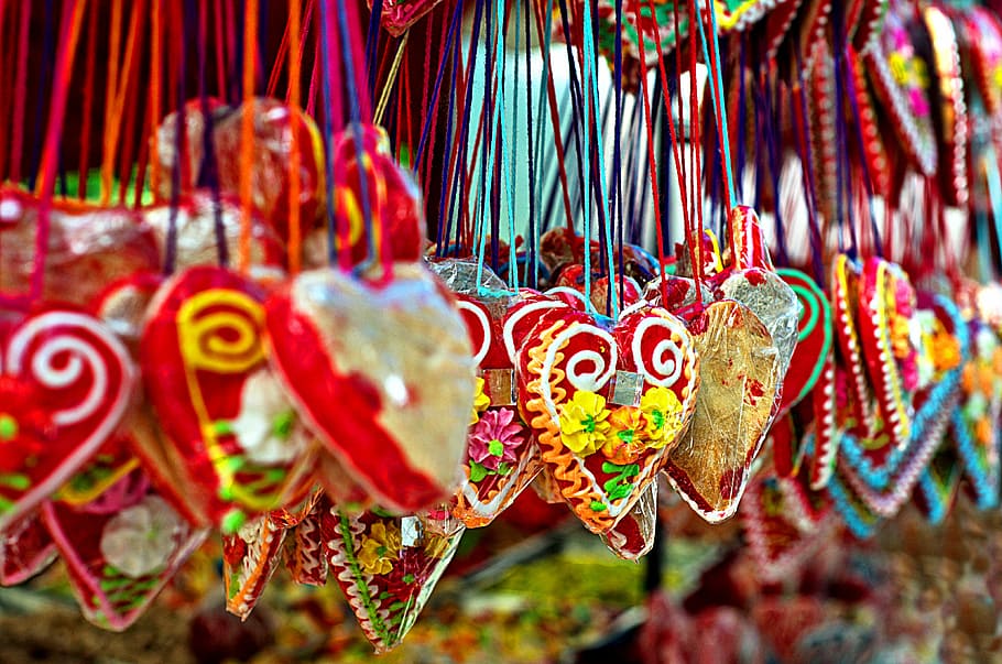 assorted-color heart hanging decors, person taking a photo of red hanging ornaments HD wallpaper