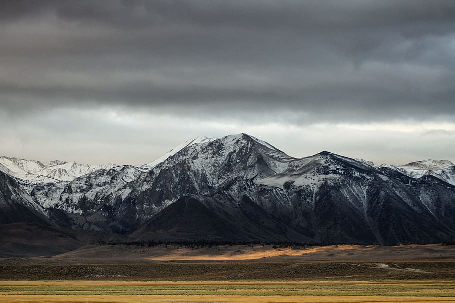 snow-covered mountain under cloudy sky during daytime, mountain covered with snow under dark clouds HD wallpaper
