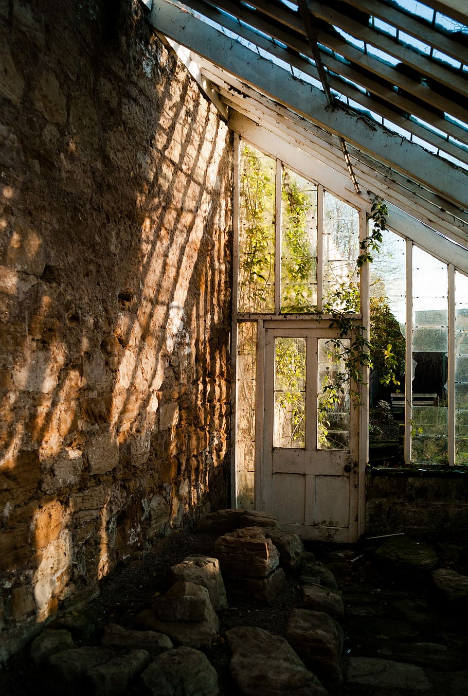 empty abandoned house at daytime, brown stone lot inside white and black storage room during daytime HD wallpaper