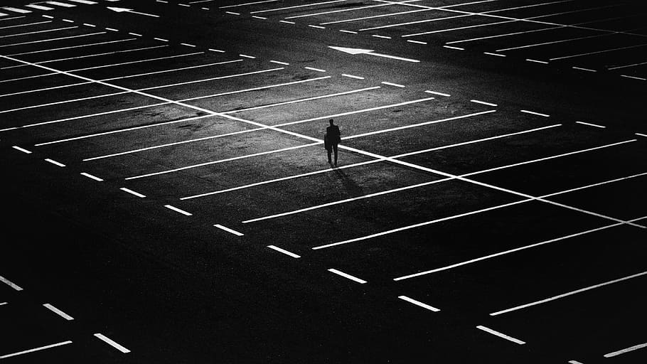 person standing on parking lot, city, people, street, night, lights