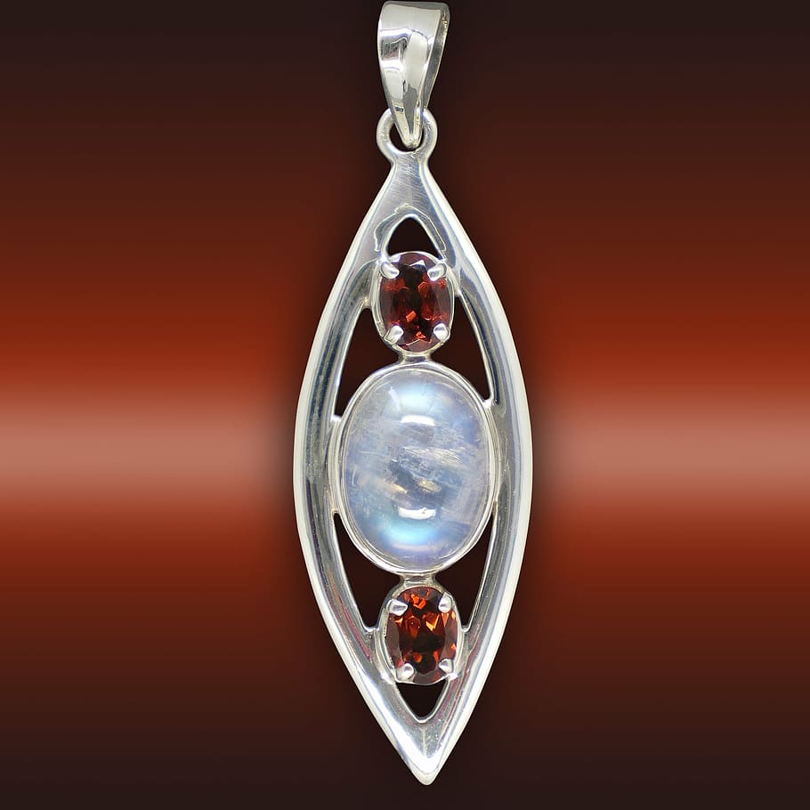 silver-colored tear-drop pendant, rubin, gems, moonstone, ground