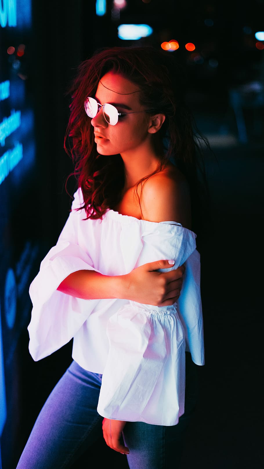 low light photography woman wearing white off-shoulder top, bokeh photography of woman near lights