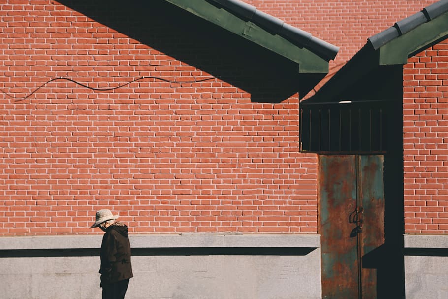person standing near the house, wall, brick, red, building HD wallpaper