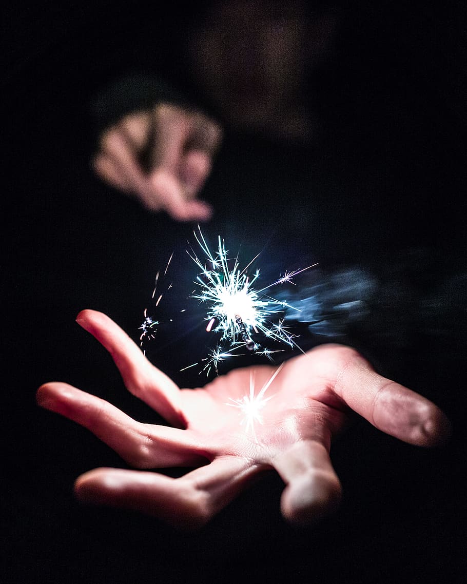 person holding sparkler, focus photography of person holding sparkler HD wallpaper