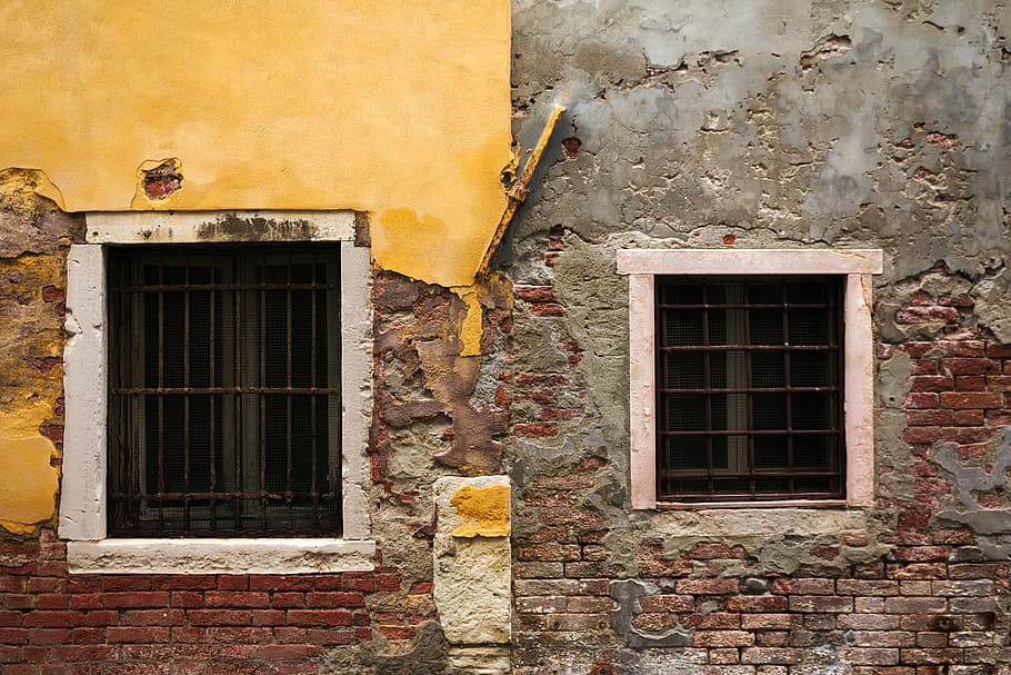 two black steel window grills, gray and brown concrete building with two windows HD wallpaper