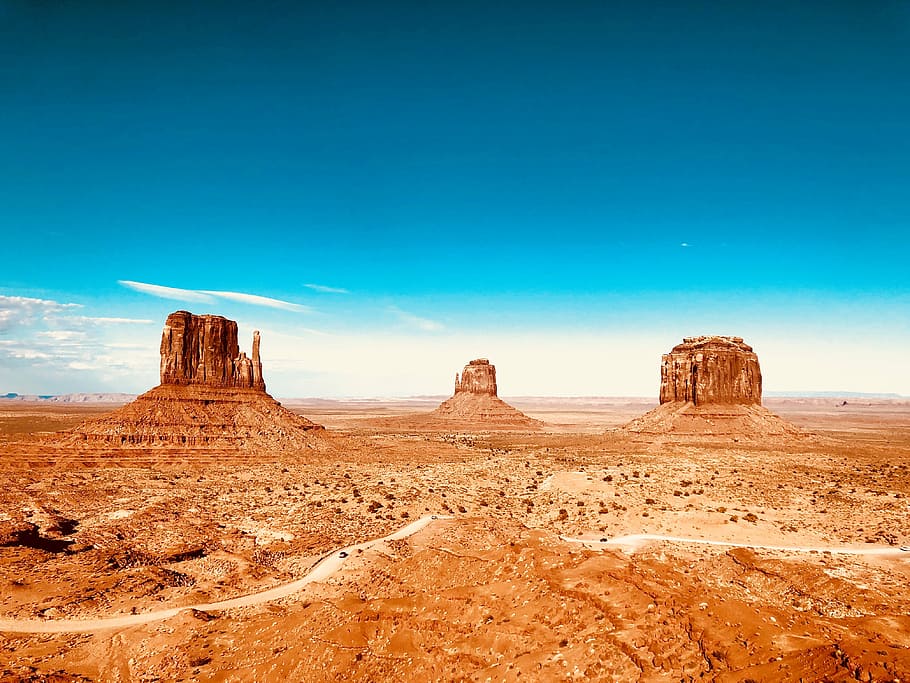 landscape photo of three brown rock formations, Monument Valley under blue sky HD wallpaper