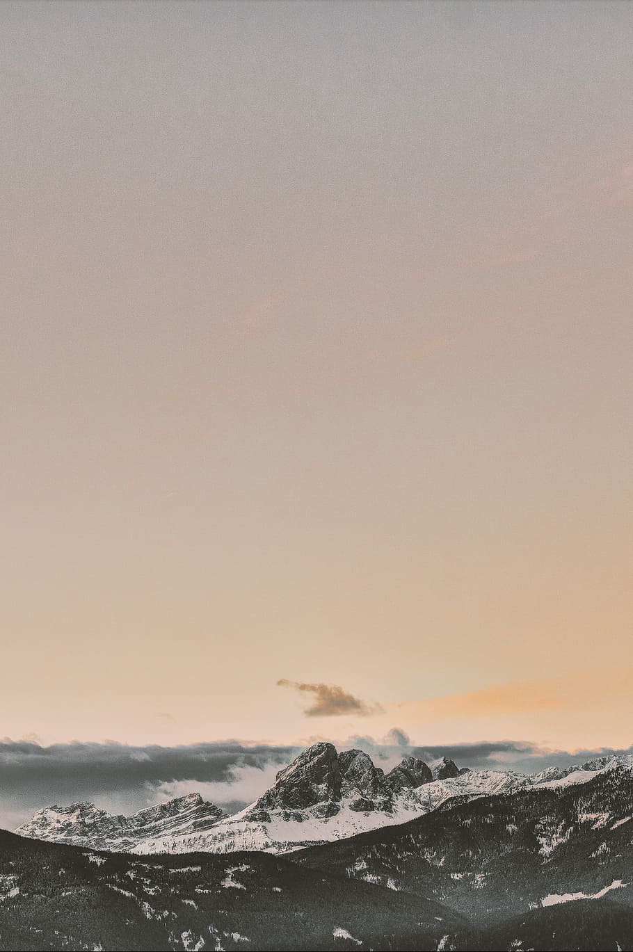 rock formation coated with snow under orange sky, glacier mountains during day HD wallpaper