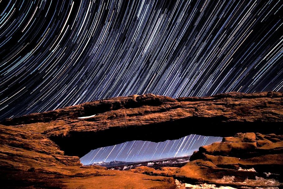 timelapse photo of stars and brown rock arch, time lapse photography of rock formations and stars HD wallpaper