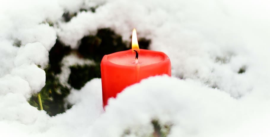 lighted red pillar candle near white snow, flame, winter, candlelight