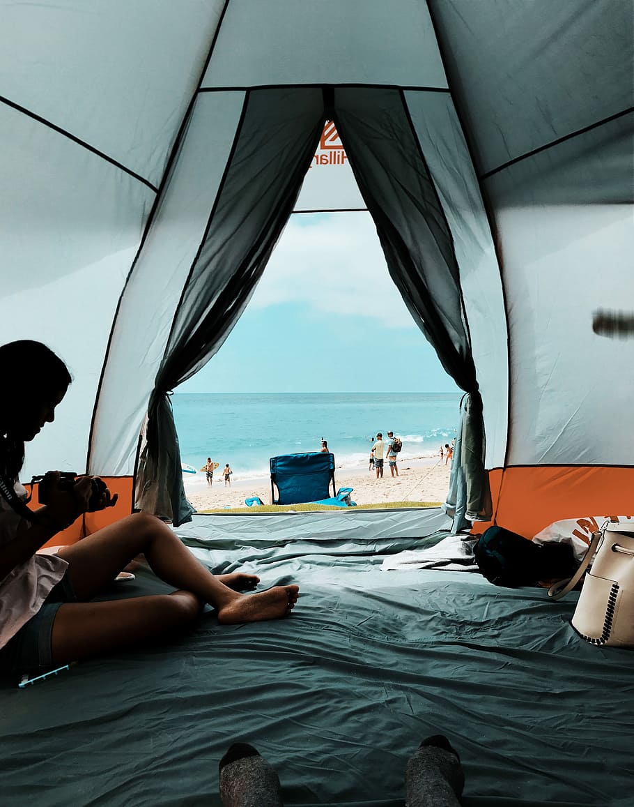 photo of person sitting inside the tent, woman sitting inside tent near seashore, HD wallpaper