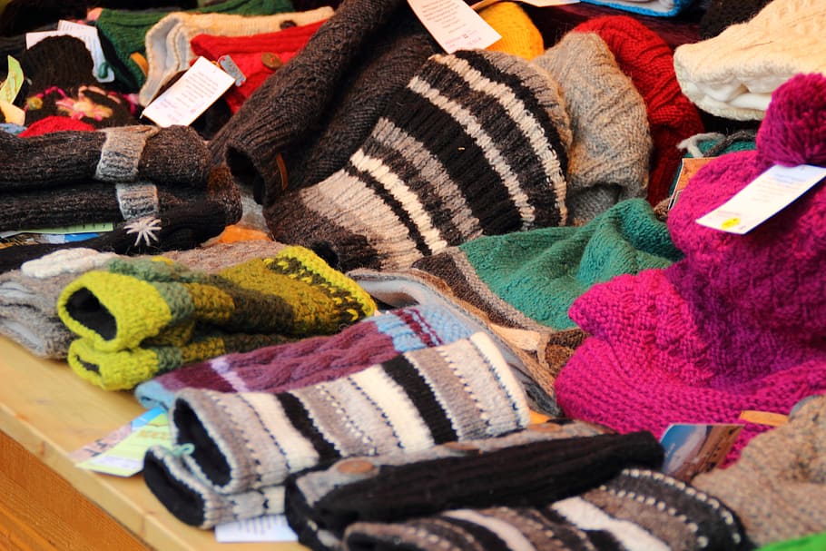 assorted-color-and-design clothes lot on brown surface, wool HD wallpaper