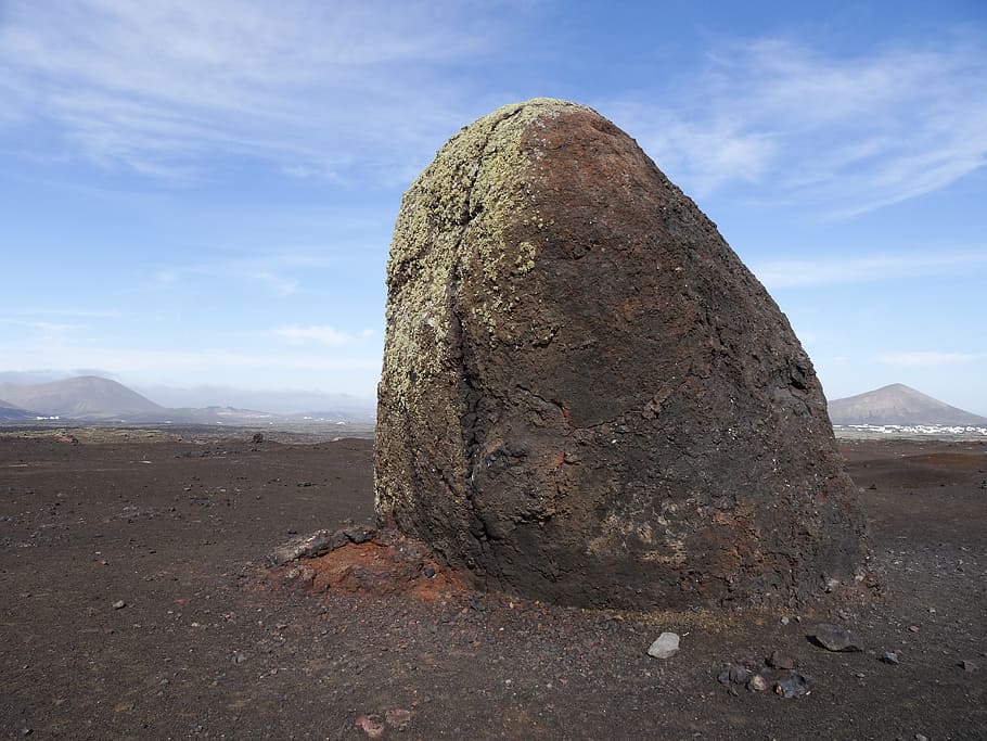 photo of brown rock on brown dessert runes during day time HD wallpaper