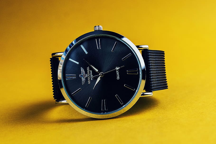 round blue face silver-colored analog watch on yellow surface HD wallpaper