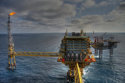 oil refinery in the middle of body of water during daytime HD wallpaper