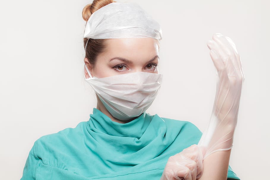 woman wearing teal top and latex gloves, doctor, medical, operation