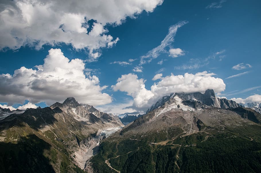 green and brown mountain under white and blue sky, white clouds on top of mountains HD wallpaper