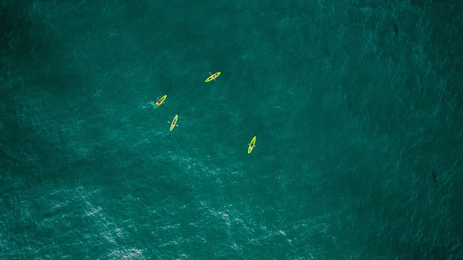 bird's-eye view photography of four boats in ocean, sea, blue