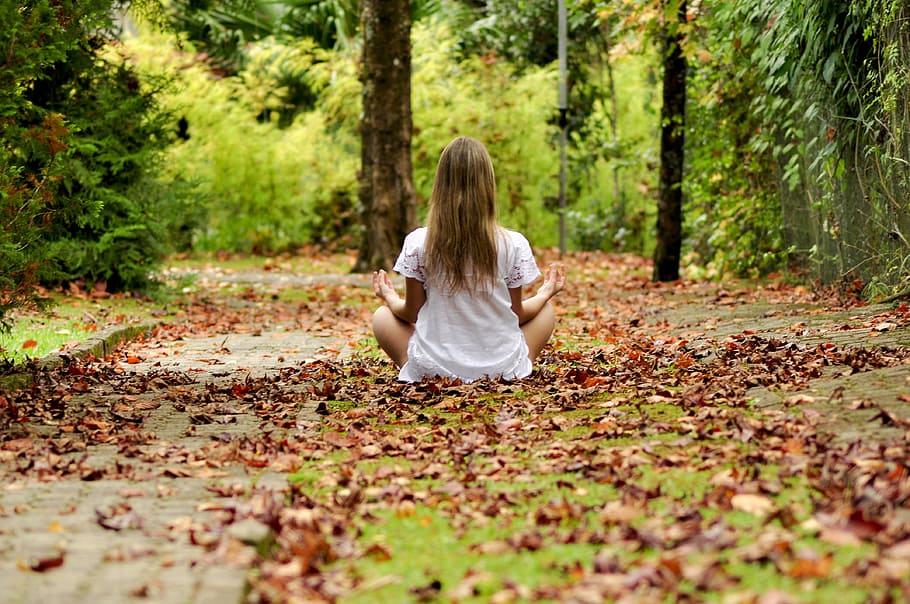woman wearing white top meditating, girl, child, forest, child playing
