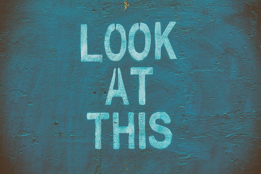‘Look at this’ stencil lettering on an urban wall, textures