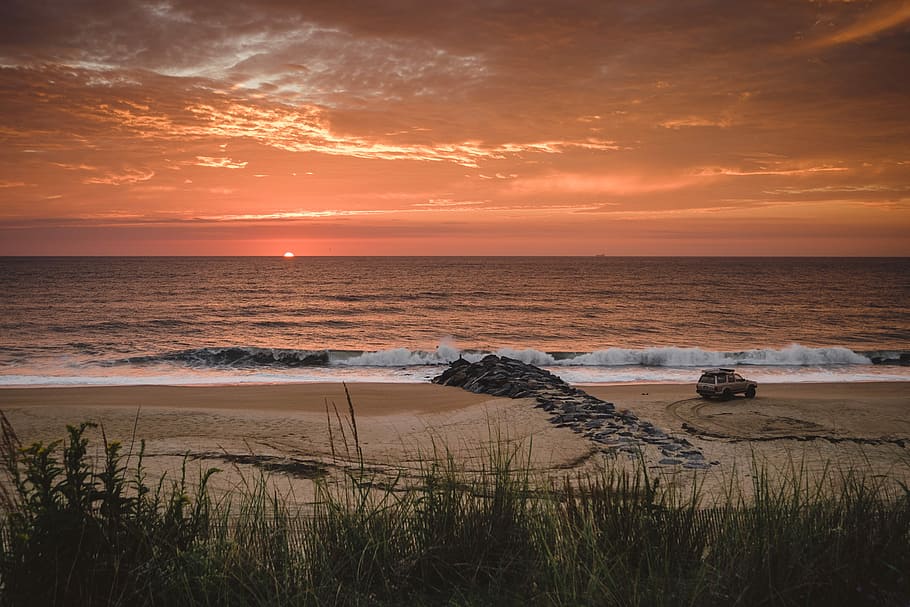vehicle on shore at golden hour, water crashing on seashore, beach HD wallpaper