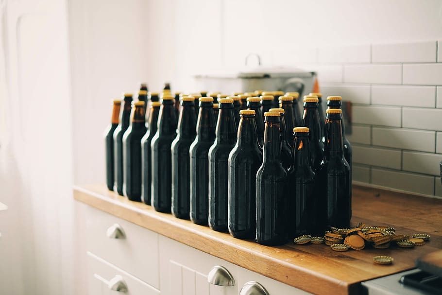 black tinted glass bottle lot on brown and white wooden cabinet, black bottle HD wallpaper