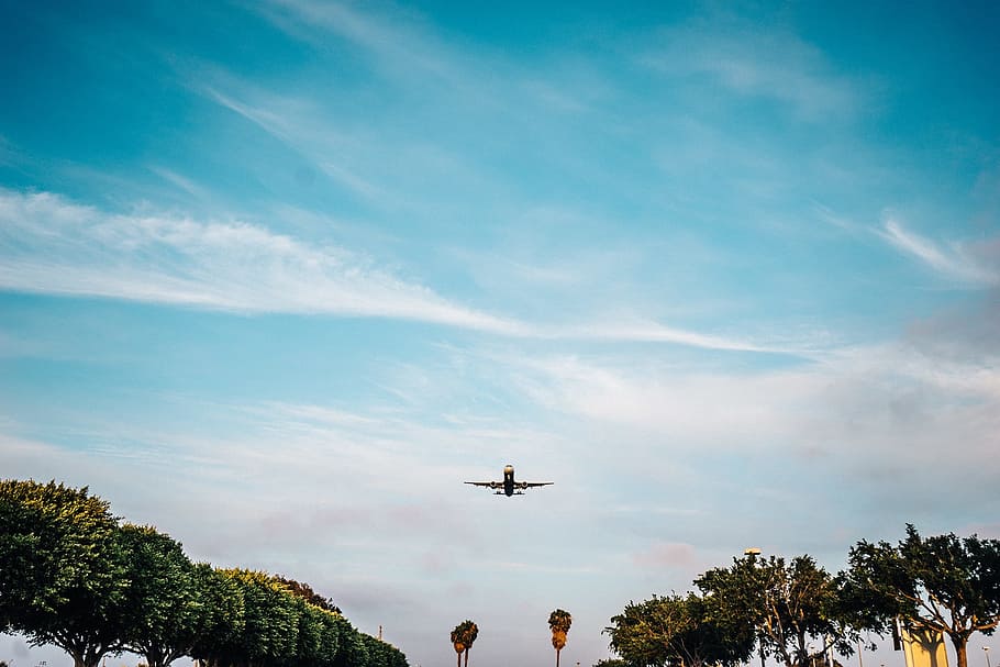 low-angle photography of airplane flying under blue sky, takeoff HD wallpaper