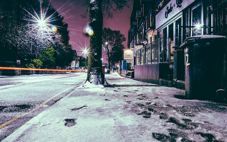 photography of street during nighttime, snow footprints on sidewalk during night time HD wallpaper