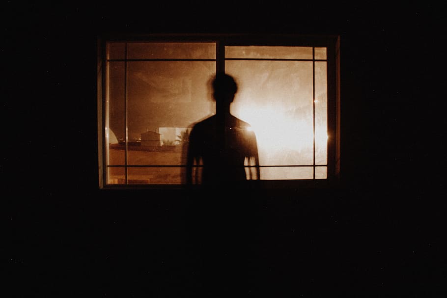 silhouette photography of person in front of window, man in front of glass window